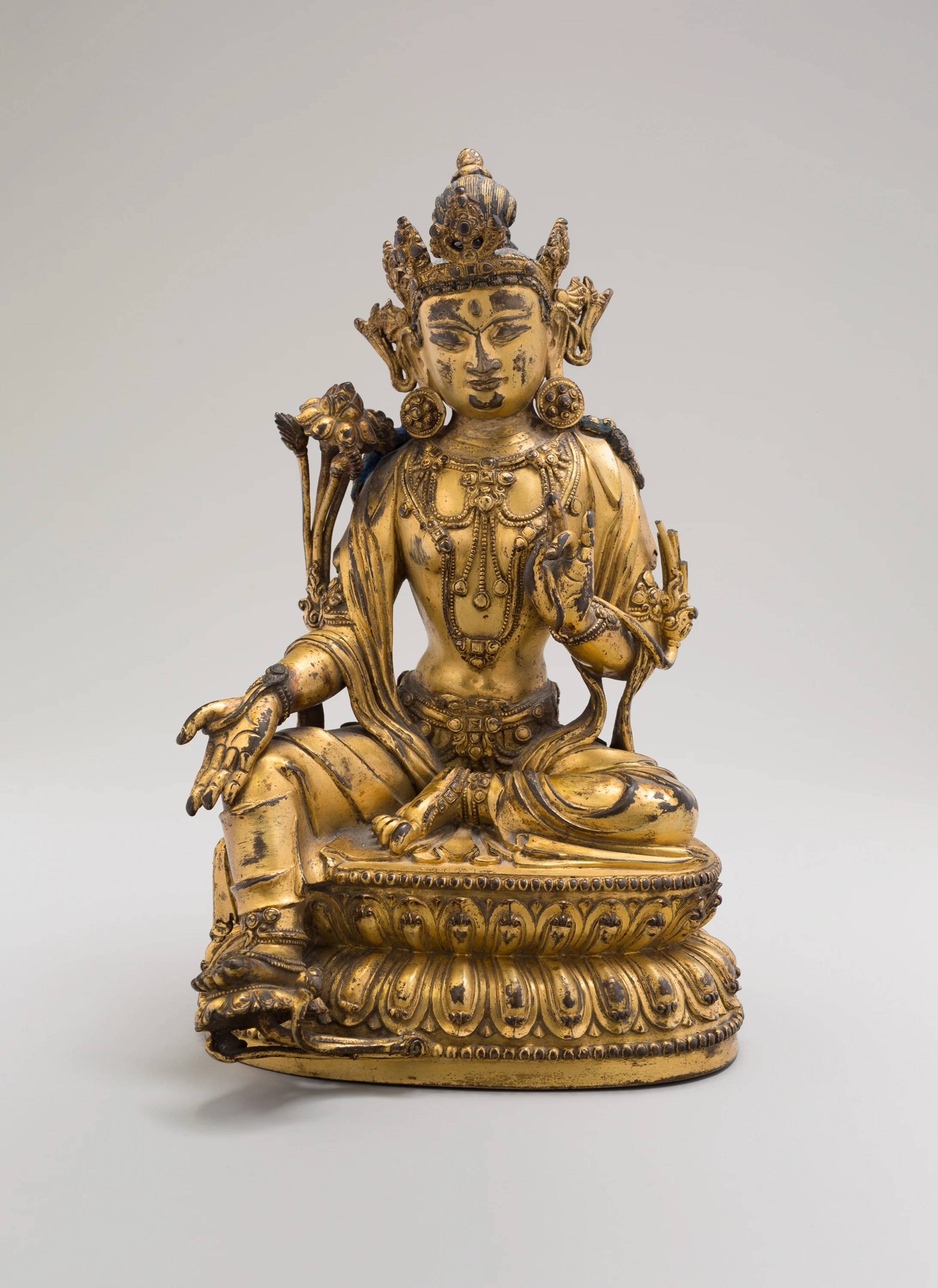 Green Tara, Seated in Pose of Royal Ease (Lalitasana), with Lotus Stalks on Right Shoulder and Hands in Gestures of Reasoning (Vitarkamudra) and Gift Conferring (Varadamudra)