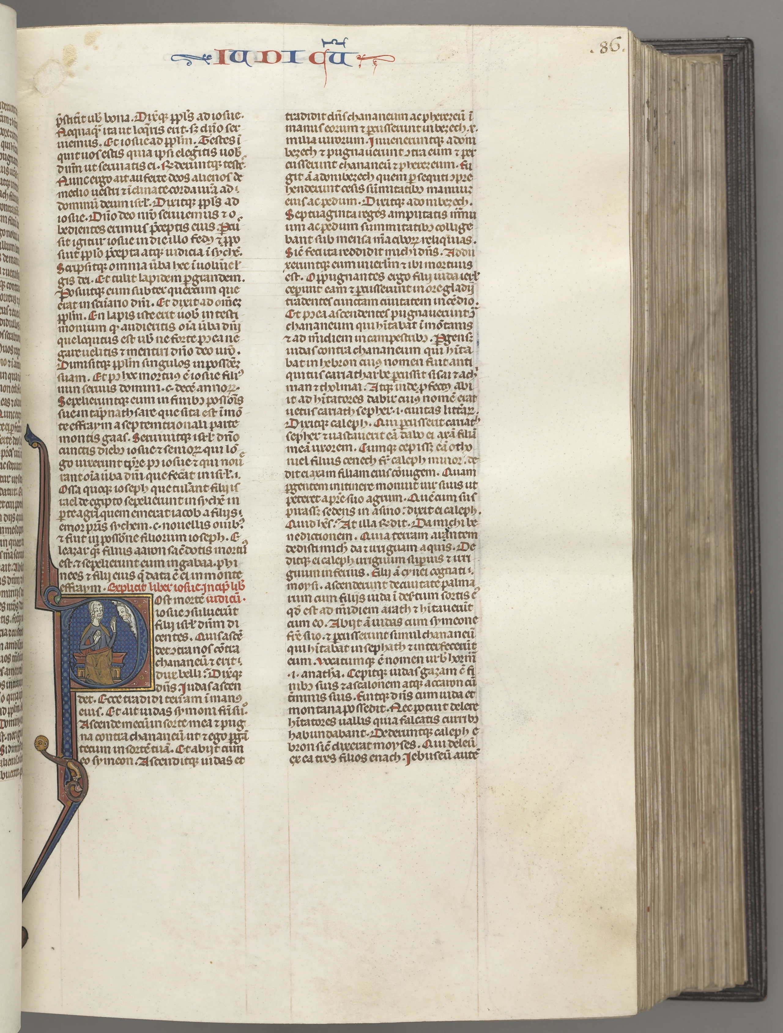 Fol. 86r, Judges, historiated initial R, Judah seated with a book talking to God