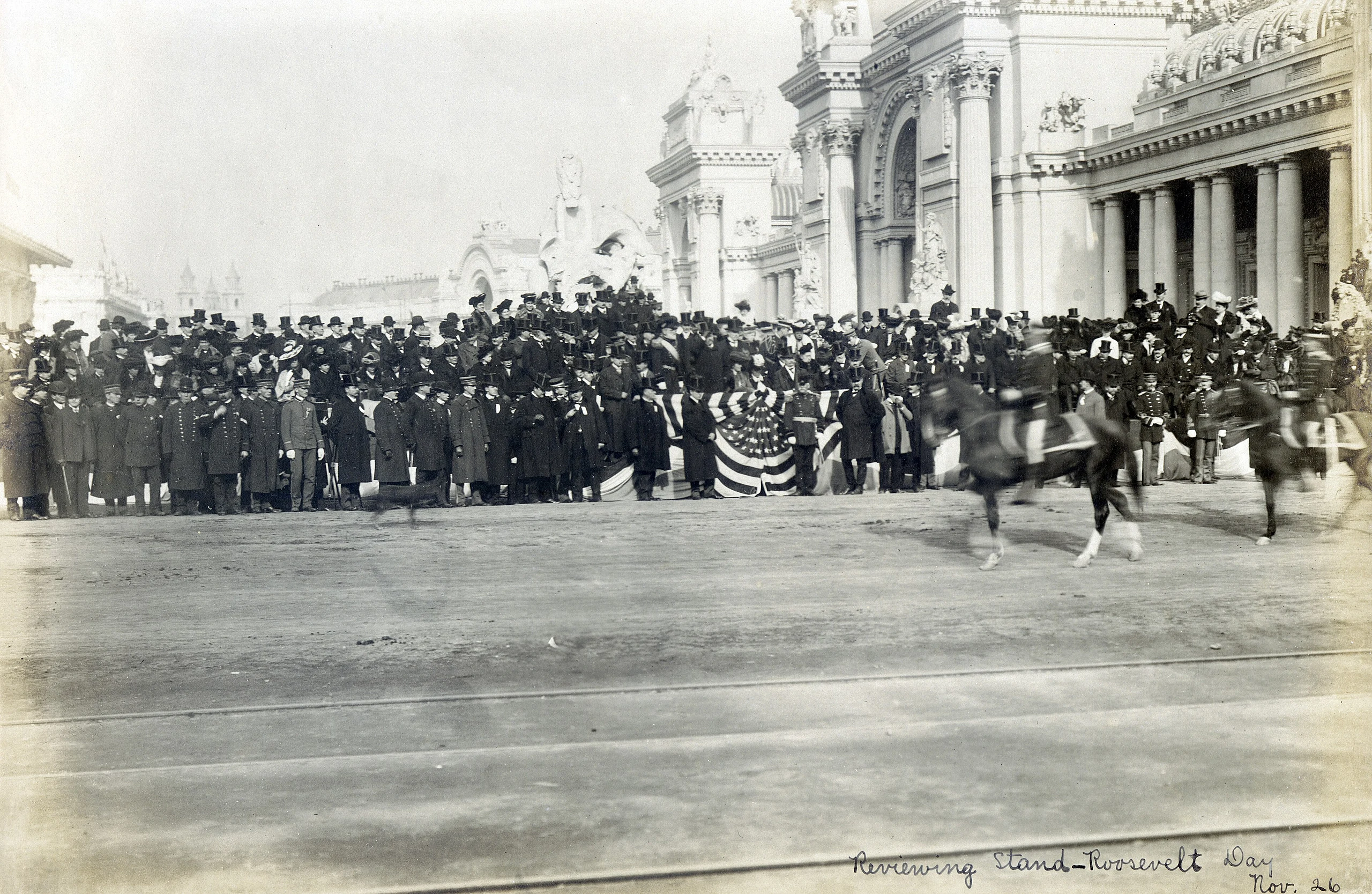 "Reviewing Stand - Roosevelt Day, Nov. 26." (Distant view of the reviewing stand on Roosevelt Day at the 1904 World's Fair).