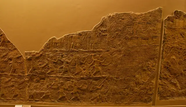 The Lachish relief — Assyrian soldiers storming a Judean city, carved in stone