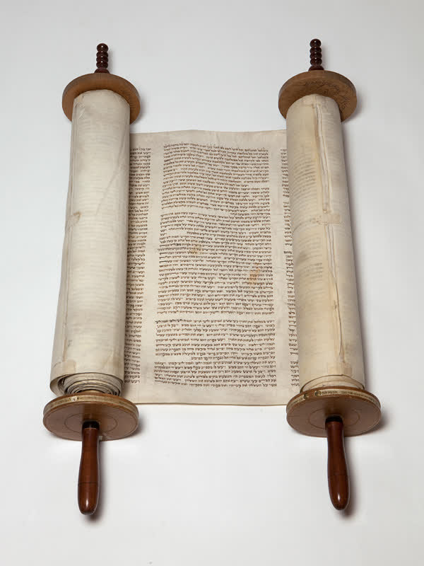 A Torah scroll from 1821, open on its rollers