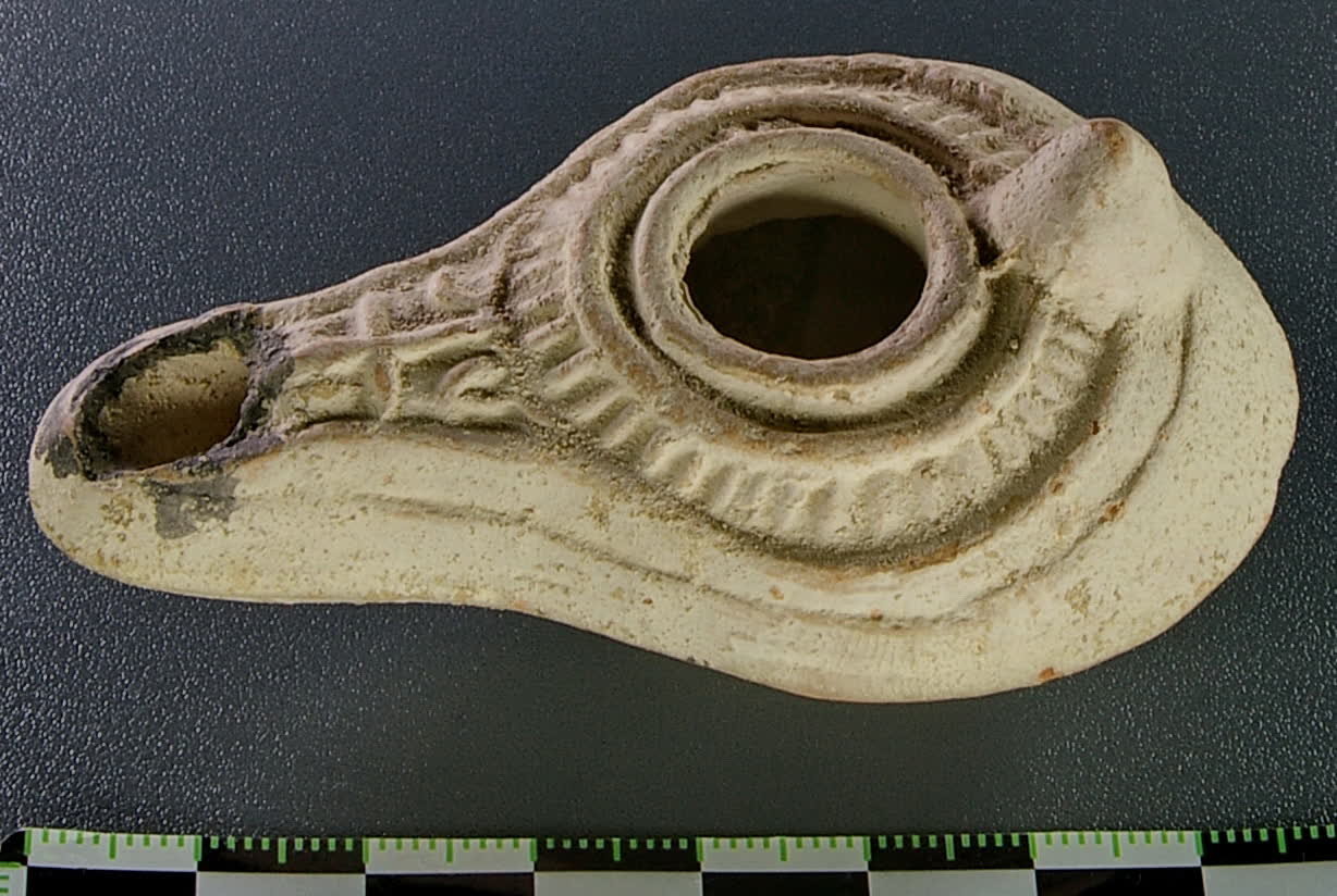 A simple clay oil lamp of the Roman era