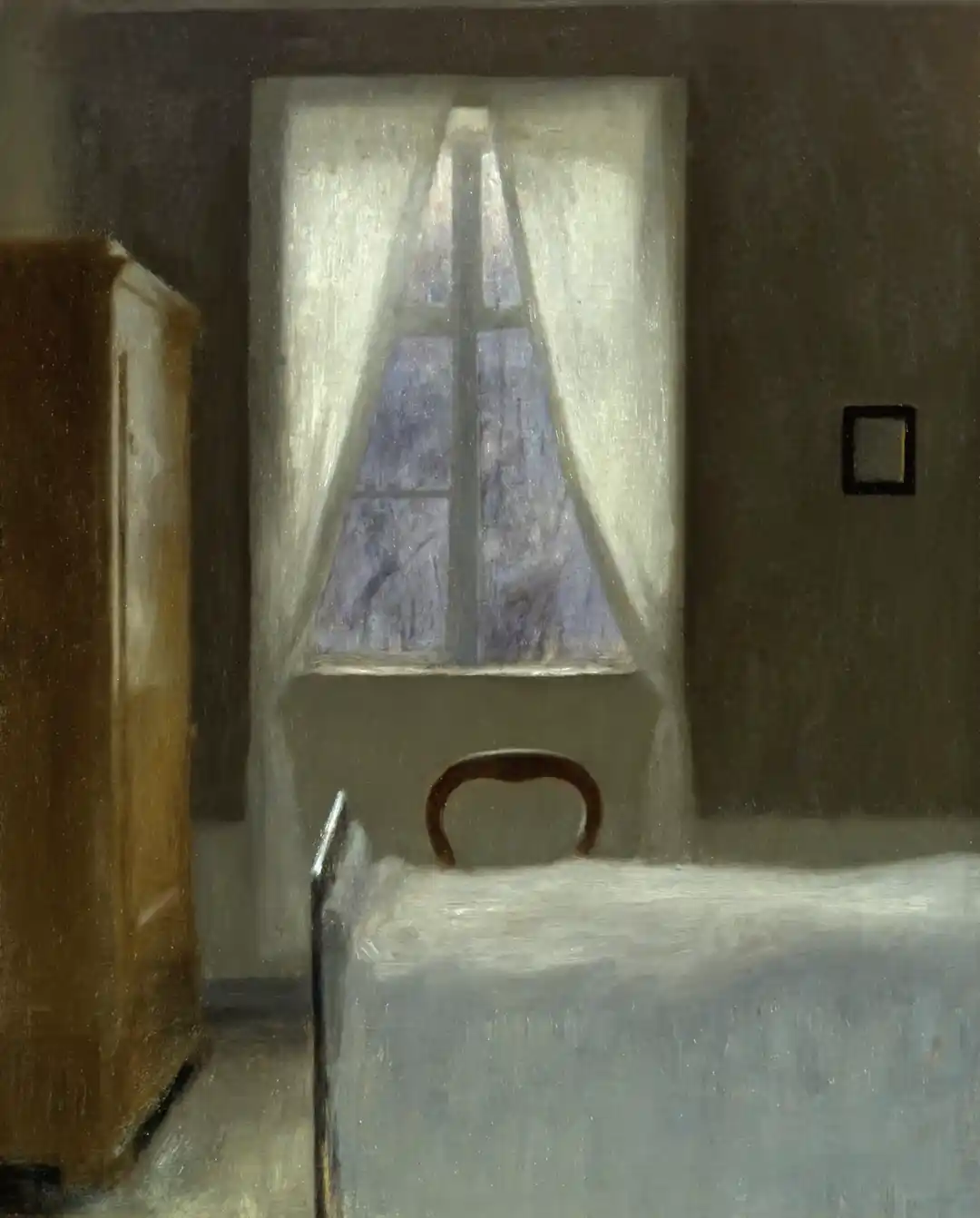 A sunlit, empty interior room — a single window, bare walls, no figure present